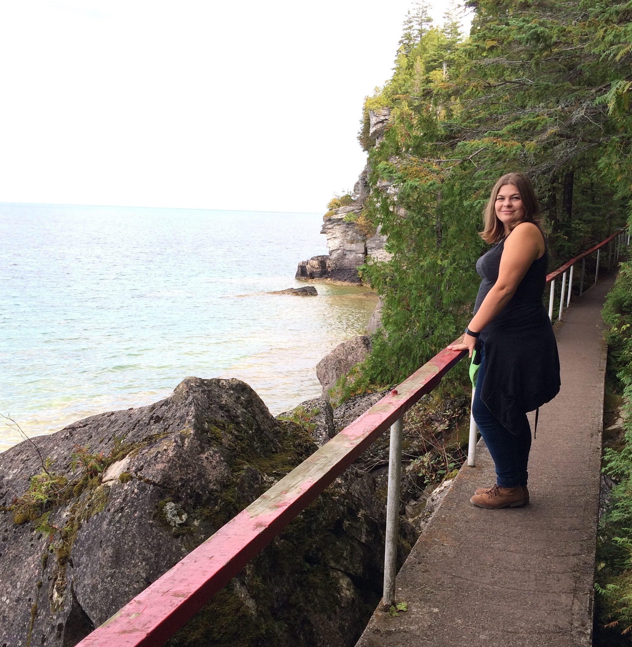 photo of Jen Pike in Tobermory Ontario, standing by a railing next to the water